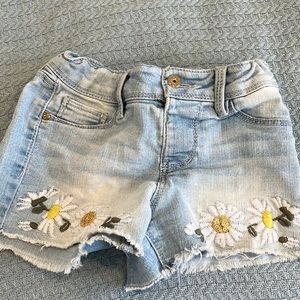 These jeans have a cute flower print on the bottom.